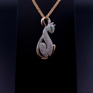 Gold pendant with zircons and colored stone